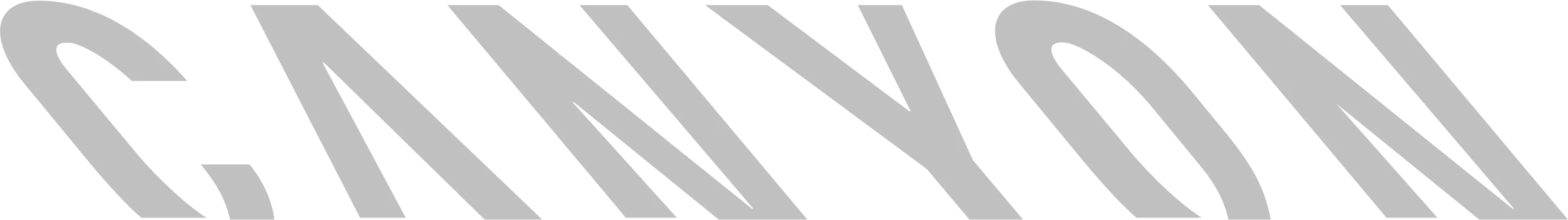 Harmaa "CANYON" -teksti mustalla taustalla, vinossa ja lihavoituna.